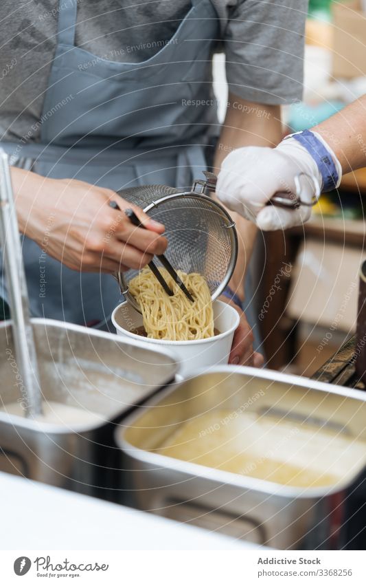 Anonymous person preparing pasta spaghetti cooked prepared fresh silver board cooking food meal cuisine traditional ingredient steel nutrition hot tasty