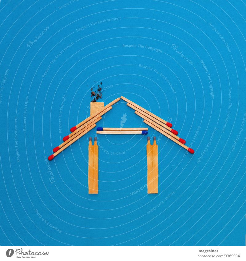 fire insurance, shape of the house made of matches. abstract house made with matches on blue paper background. Concept of home protection insurance with the importance of smoke detectors