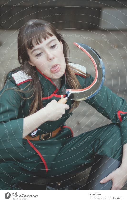 girl in uniform with sickle in her hand and indicated cutting of the neck Photochallenge Young woman Face Uniform Soldier Weapon Threaten symbol Might