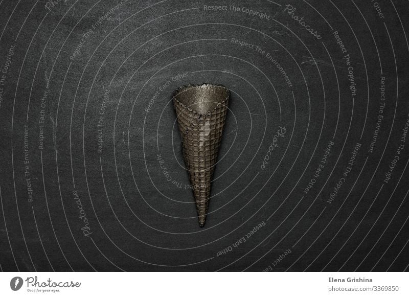 Empty black ice cream cone on a black background. Dessert Ice cream Style Dark Hip & trendy Brown Black Colour Idea Creativity Waffle Conceptual design Minimal