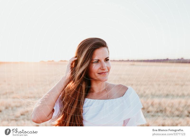 portrait of young beautiful woman on countryside at sunset outdoors caucasian summer lifestyle happiness smile adult nice girl nature pretty lash slim face