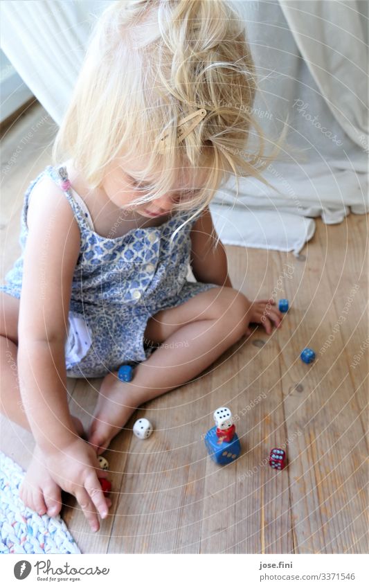 dice game Joy Healthy Playing Children's game Living room Study Feminine Toddler Girl Infancy Body Blonde Drape Movement Sit Happy Curiosity Blue White