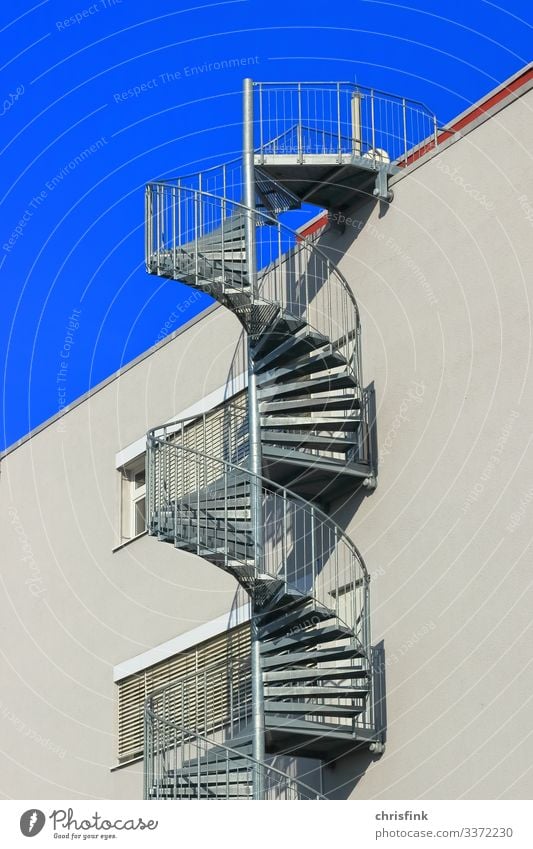 Winding staircase to house Colour photo Shadow Light Day Exterior shot Gray Trust Spiral Escape route Blue Athletic Glass Concrete Roof Stairs