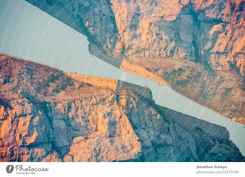 Multiple exposure of warmly illuminated rocks with fortress in front of a blue sky Back-light Sunbeam Contrast Shadow Light Day Deserted Exterior shot