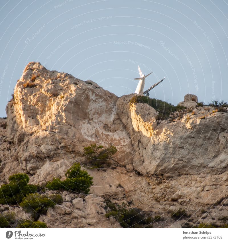 Illusion of a plane crash Airplane Aircraft crash Rock frankreis Marseille Perspective Summer Sky Absurd Whimsical Flying Crash Descent Airplane landing