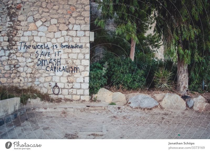 Wall with writing: The world is beautiful, save it, destroy capitalism Day Deserted Exterior shot Colour photo Economic crisis Sustainability