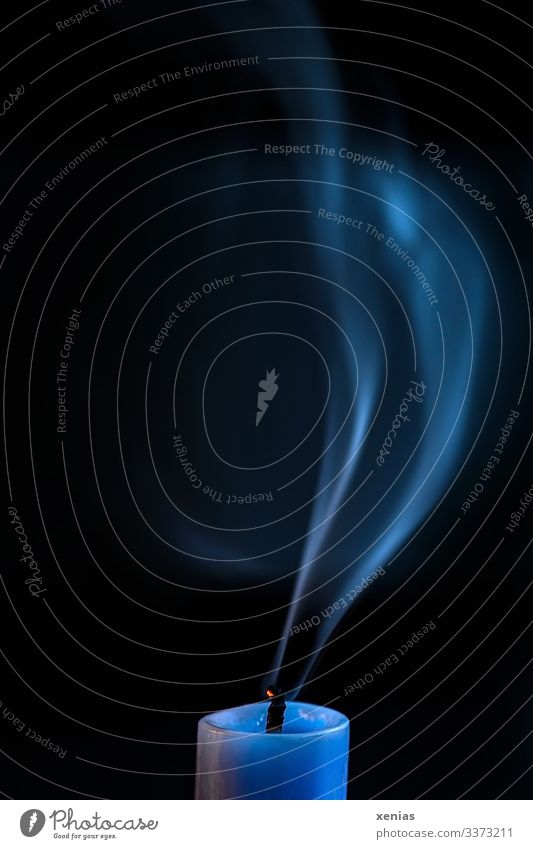 Blue candle with smoke in front of black background shoulder stand Black Smoke Candlewick conceit Haze Copy Space top Twilight Night Motion blur