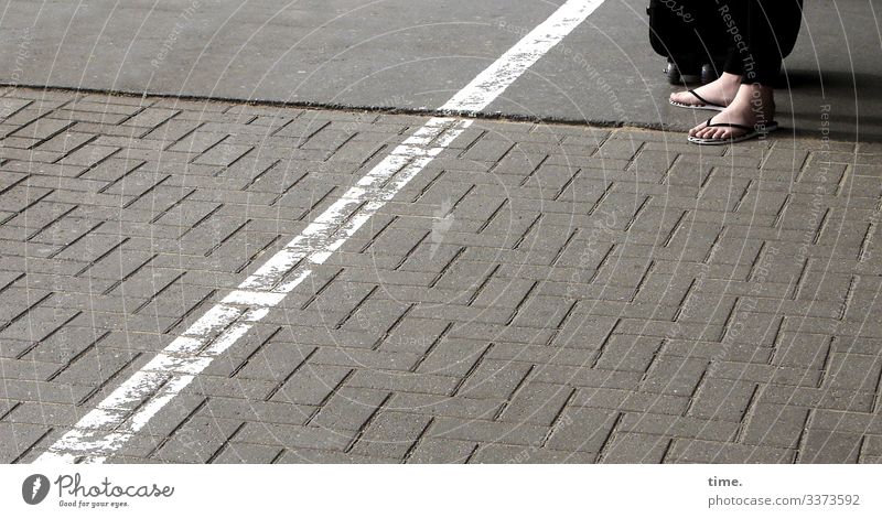 Patience on the platform Platform daylight feet Barefoot Woman Suitcase Flip-flops Stripe Asphalt Places stones Stand Wait patience Border Safety Protection