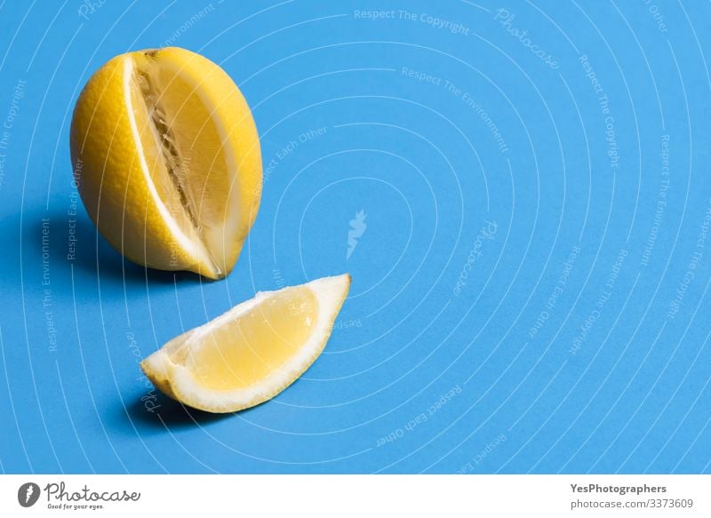 Ripe lemon and one slice of lemon. Citrus fruits. Fresh fruits Fruit Healthy Eating Blue background citrus fruit colorful Copy Space food fresh fruit