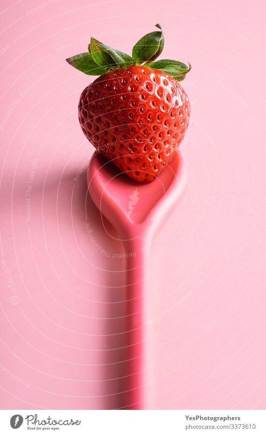 Single strawberry on a spoon. Ripe strawberry on pink Food Fruit Dessert Organic produce Spoon Fresh colorful cute fruit diet food fresh fruit fresh strawberry