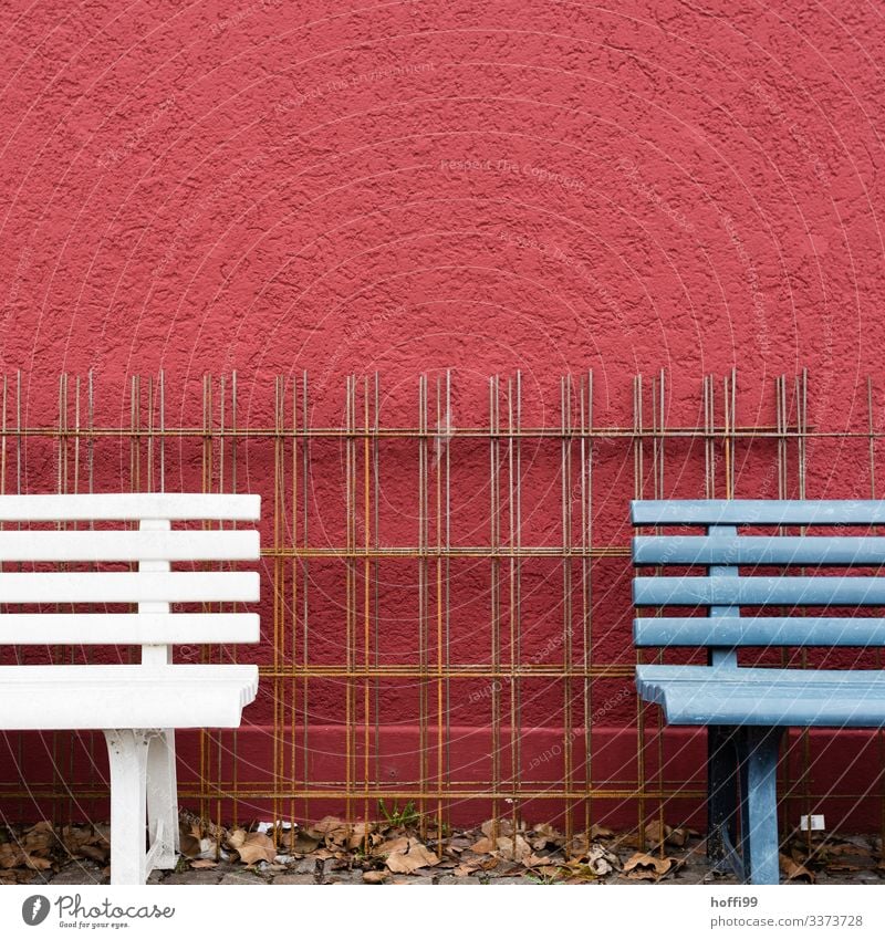 Fragment of two benches with steel grid in front of red wall Bench fragments reinforcement steel armouring corrosion Reinforcement mesh reinforcing bars