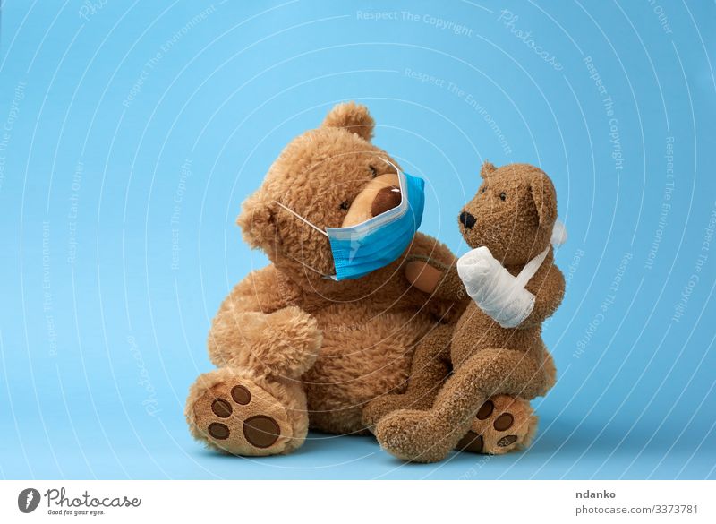 big brown teddy bear sits in a medical mask Joy Illness Medication Hospital Baby Infancy Animal Paw Toys Doll Teddy bear Sadness Small Funny Cute Soft Blue