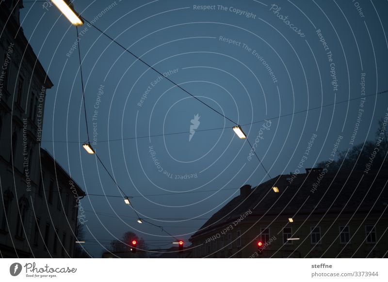 Evening atmosphere in the neighbourhood with lanterns Street lighting Traffic light Upward evening mood blue hour geometric Lamplight Kiez Small Town