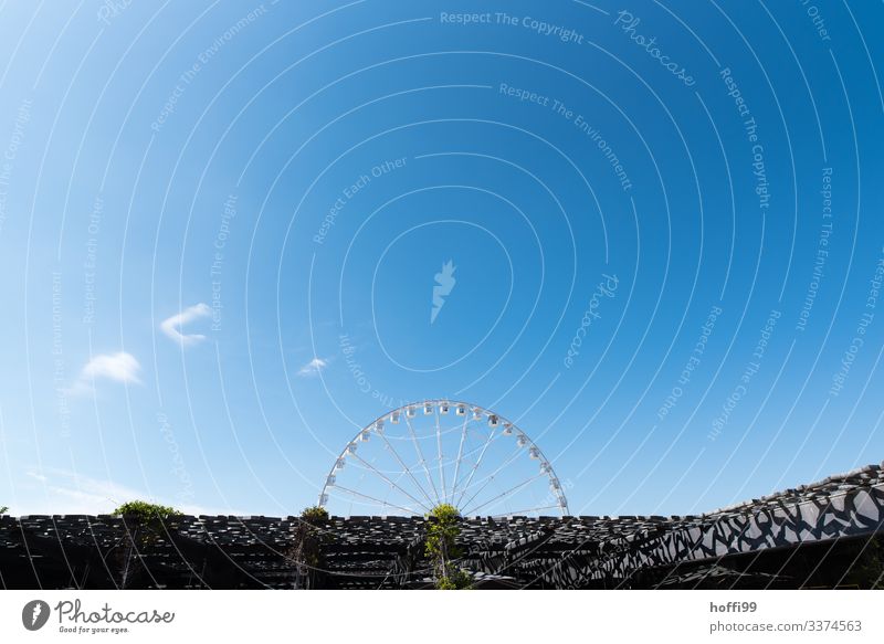 half a Ferris wheel in front of a deep blue sky Cloudless sky Sunlight Beautiful weather Manmade structures Museum Facade Terrace Roof Esthetic Authentic