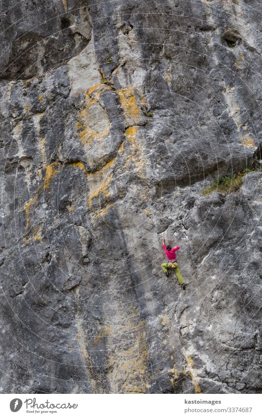 Strong girl climbs on a rock, doing sports climbing in nature. Lifestyle Vacation & Travel Adventure Mountain Hiking Sports Climbing Mountaineering Success Rope