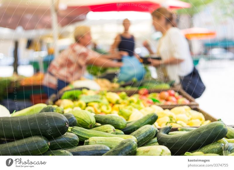 Blured unrecodnised people buying vegetable at farmers' market. Food Vegetable Nutrition Vegetarian diet Shopping Garden Decoration Woman Adults Marketplace