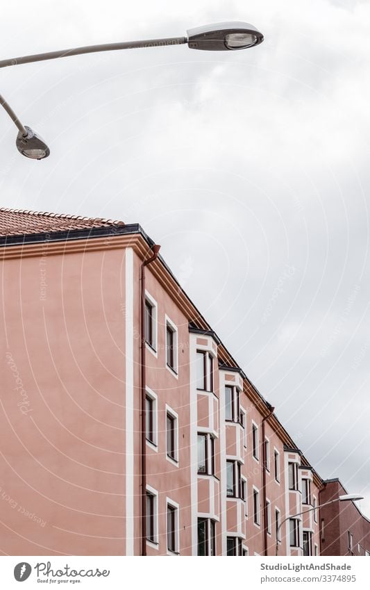 Pink building and streetlight house windows wall roof Europe European Stockholm Sweden Swedish Scandinavia Scandinavian streetlamp urban city town pastel pink