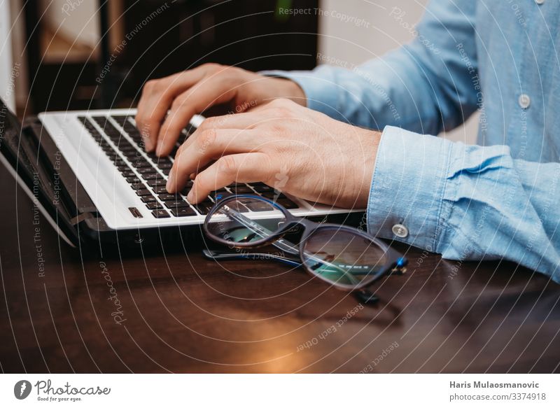 Businessman typing on computer laptop in the office with glasses on the table Notebook Keyboard Technology Advancement Future Man Adults Hand Fingers 1