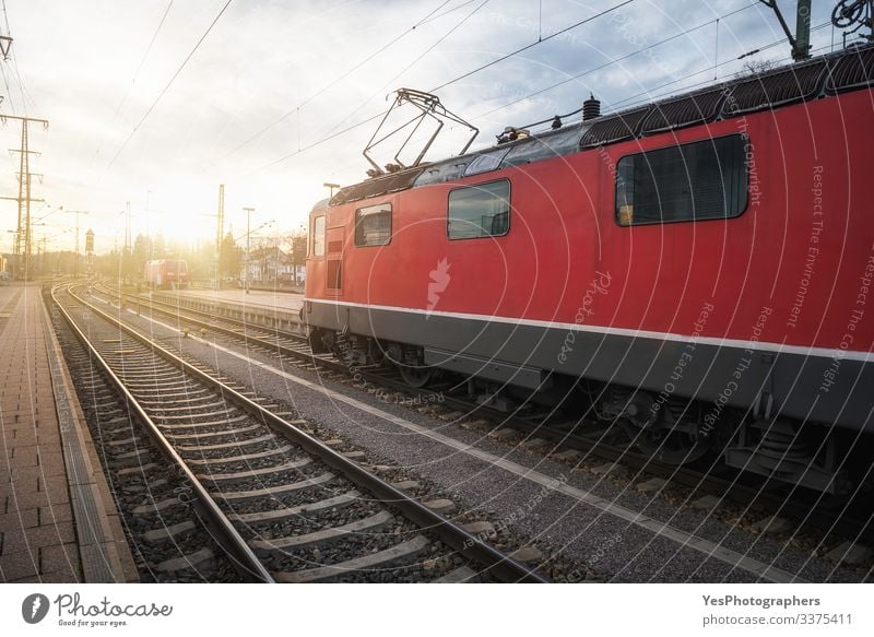 Red locomotive on railway tracks in german train station Vacation & Travel Machinery Beautiful weather Train station Transport Means of transport