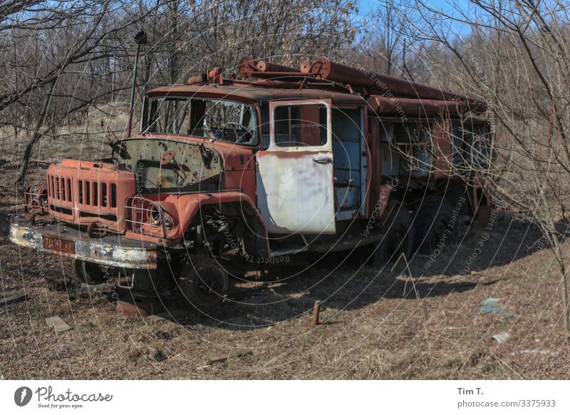 FIRE WEAR Rush hour Vehicle Truck Fire engine Creepy Historic Environmental pollution Decline Past Transience Ukraine Colour photo Exterior shot Deserted