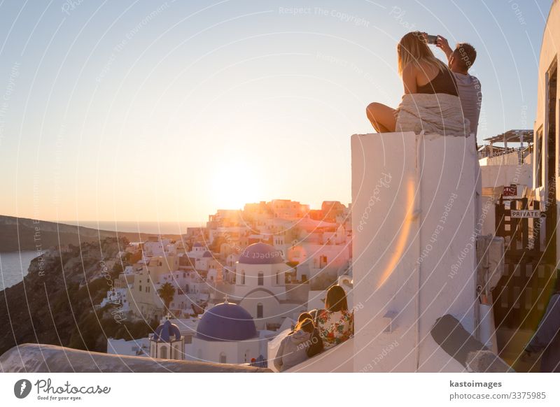 Couple watching sunset at Santorini island, Greece. Lifestyle Happy Beautiful Relaxation Vacation & Travel Summer Sun Ocean Island Camera Woman Adults Man