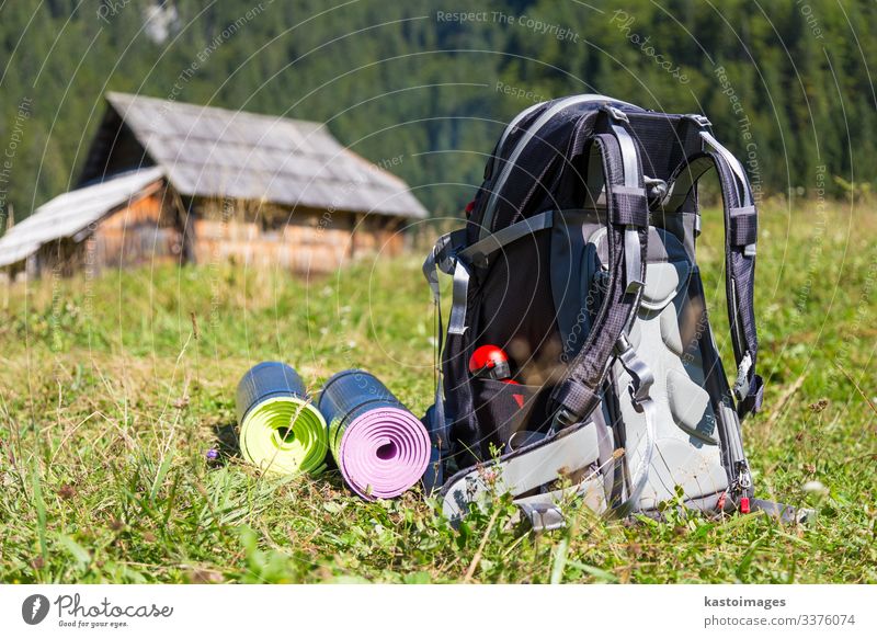 Backpack and yoga mats on mountain meadow. Vacation & Travel Tourism Trip Adventure Camping Mountain Hiking House (Residential Structure) Sports Nature Grass