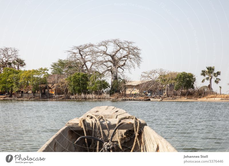 View of dugout canoe on small island village in the Casamance Dugout boat Pirogue ship Fisherman Angler ropes Anchor bow Water River Marsh Mangroves Senegal