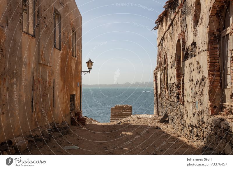 View between the canyon of houses from the island La Gorée to Dakar Senegal Slave Island Africa Sun Sand Ocean ocean Harbour detachment Ferry Tourism vacation