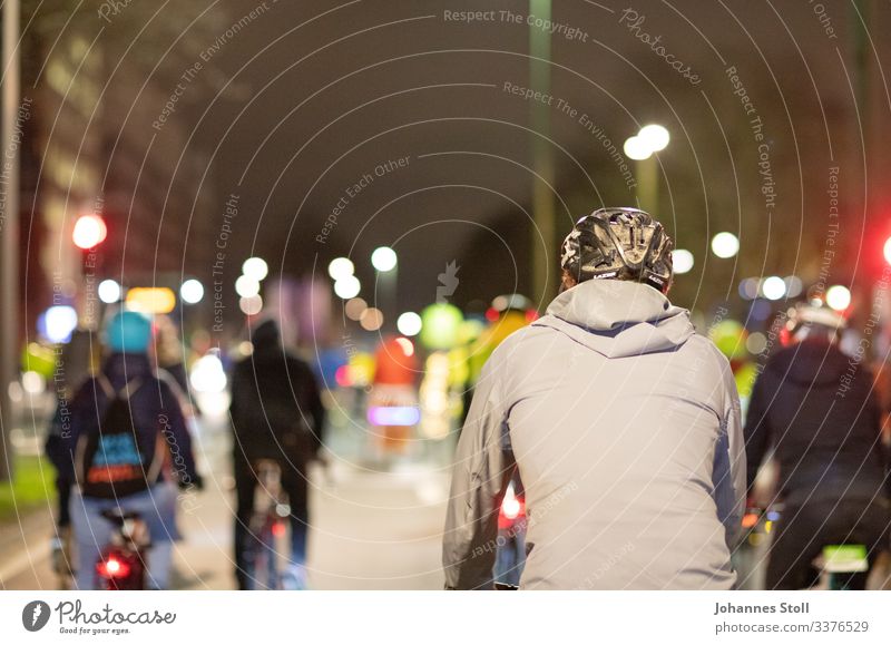 Bicycle demo Helmet Jacket Town urban Demonstration Commuter Climate protection Transport jam Motoring group Lantern Night Evening darkness Security peril