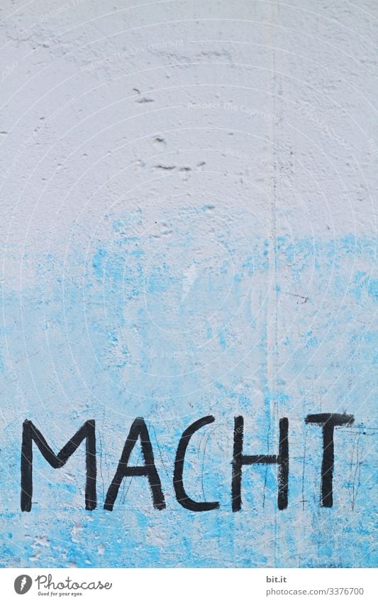 makes Might Power struggle Wall (barrier) Wall (building) Blue Facade Architecture House (Residential Structure) Letters (alphabet) Characters writing Text Sign