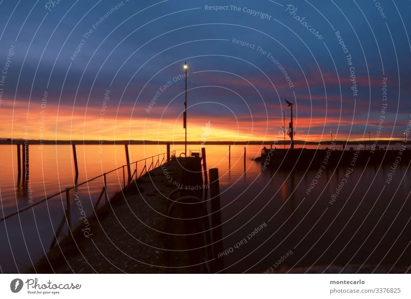 Winter sunset in the harbour of Meersburg on Lake Constance Light Evening Sunlight Exterior shot Colour photo Warmth already Authentic Harbour Weather Horizon