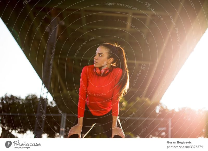 Attractive female runner taking break after jogging outdoors Lifestyle Relaxation Sports Jogging Human being Young woman Youth (Young adults) Woman Adults 1