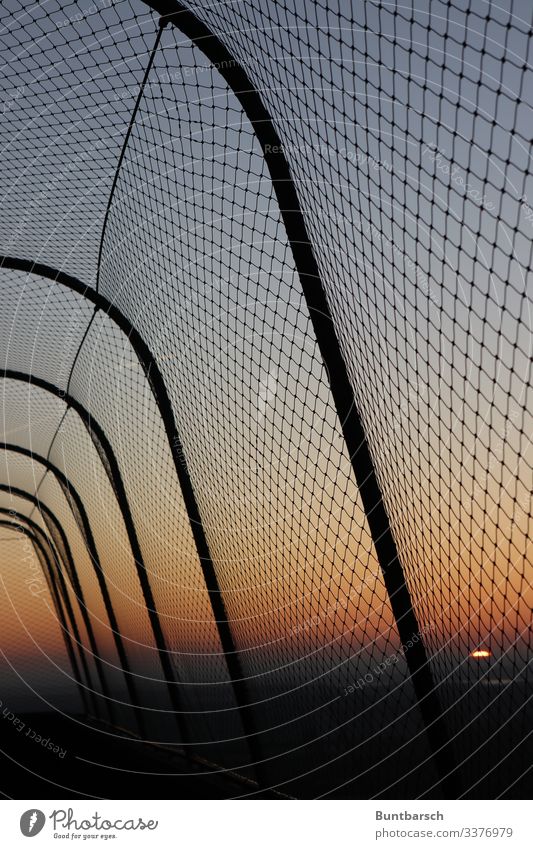 Safety fence in the evening light Fence protective fence Border Wire netting Wire netting fence sunset Sunset Orange Metalware Barrier Deserted Exterior shot