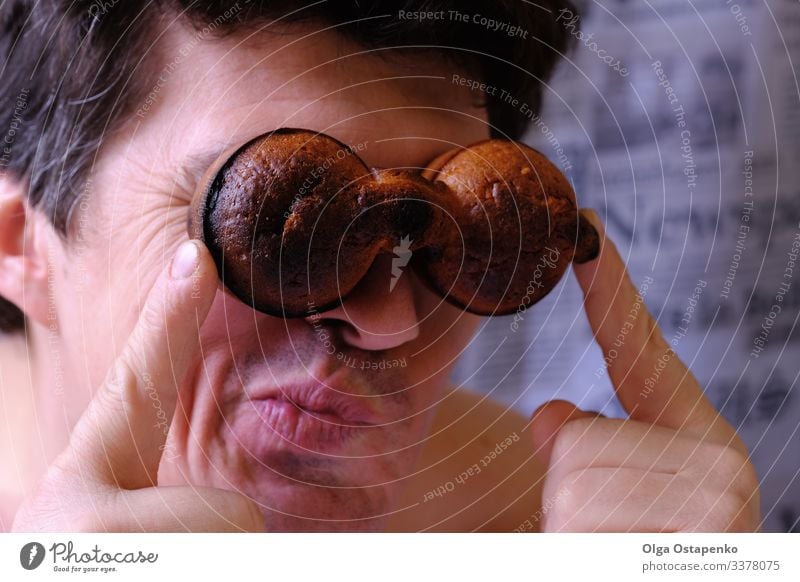 Funny happy man looking through binoculars of two muffins Happy Man Looking Binoculars Cupcake Smiling Future Adventurer Success 18 - 30 years Observe White