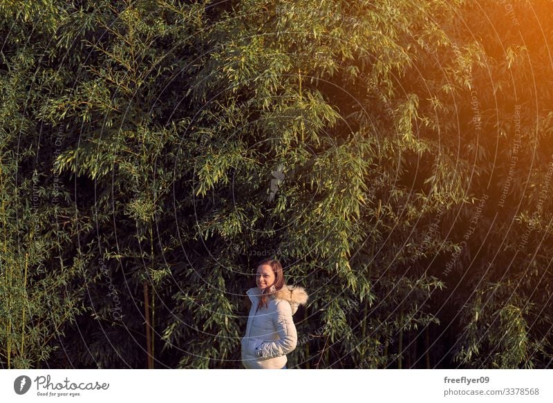 Young woman in front of a bamboo plantation young leaves green grass nature plants japanese leaf culture garden tropical background zen freshness tree asia