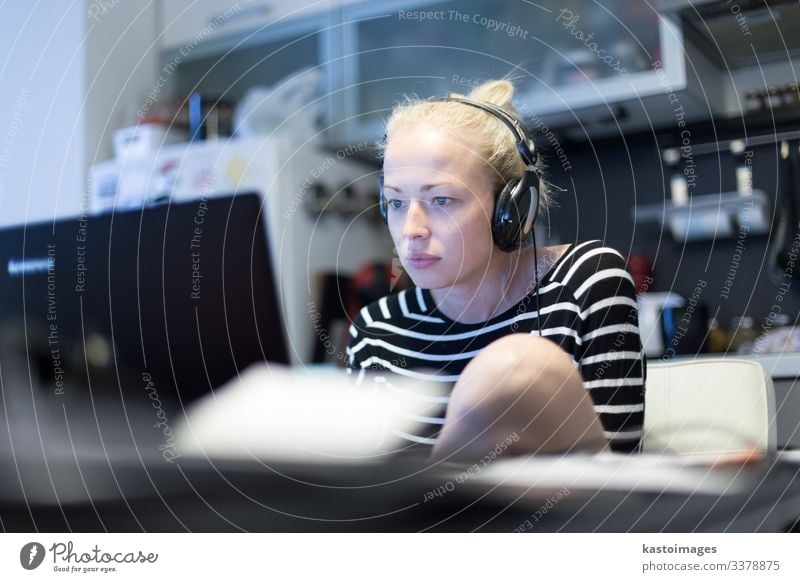 Woman in her casual home clothing working and studying remotely from her small flat late at night. Lifestyle Calm Reading Far-off places Table Kitchen