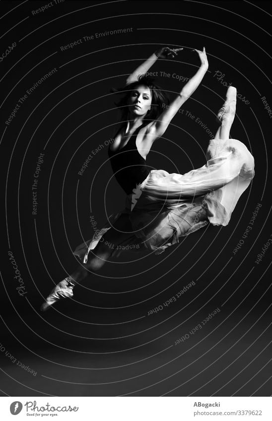 Ballerina in stag split leap, female ballet dancer in striking flying pose ballerina jump bw woman beautiful vintage retro clothes skirt dancing vitality