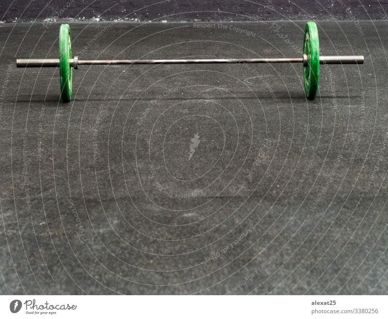 Green barbells on black floor active background bodybuilding copy space equipment exercise fit fitness green gym health healthy iron isolated lifting motivation