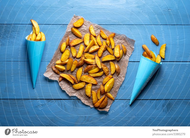 Vegetable Dinner Fast food Delicious Gold above view american fries Baked potato baked wedges blue cones blue table crispy fries famous food flat lay