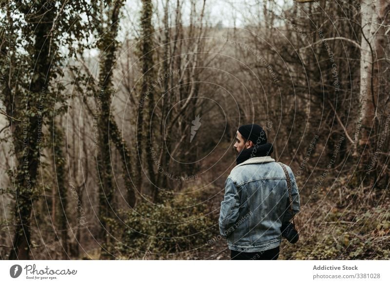 Thoughtful tourist with camera looking at mountain landscape valley travel nature trip adventure man vacation autumn traveler beard tourism holiday