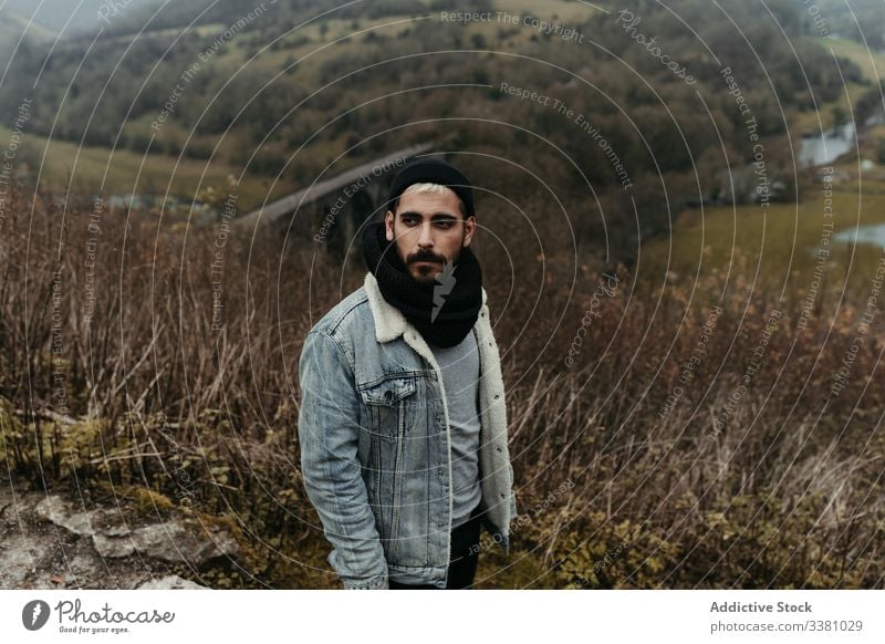 Thoughtful tourist with camera looking at mountain landscape valley travel nature journey trip adventure man vacation autumn traveler beard tourism holiday