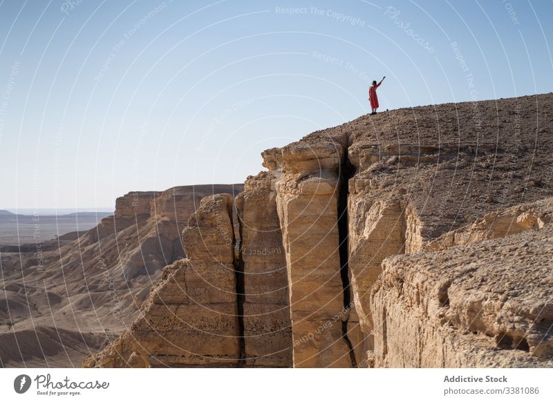 Unrecognizable female tourist contemplating horizon in desert contemplate woman cliff rest nature travel adventure rock freedom journey vacation terrain tourism