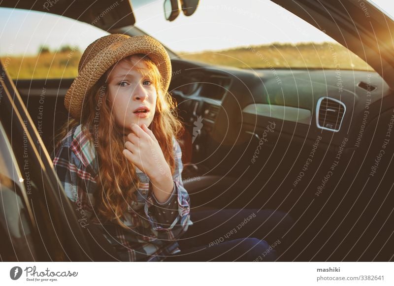 happy child girl relaxing in car during summer road trip. Exploring new places, traveling on summer vacations. nature outdoor auto drive freedom lifestyle fun