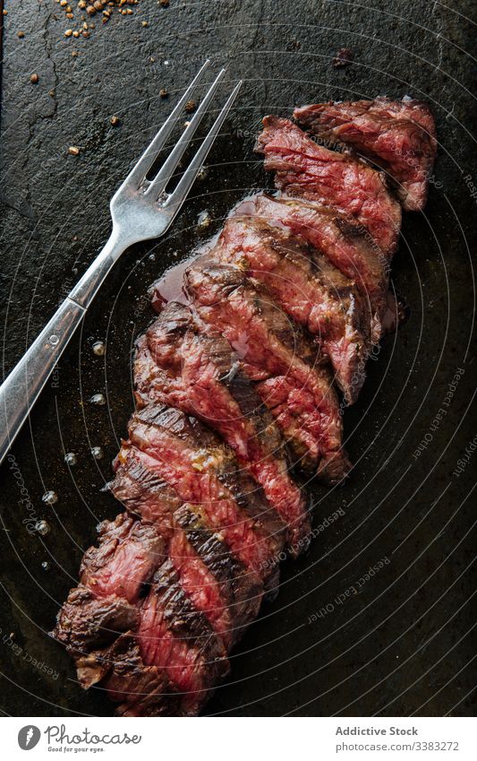 Juicy cuts of colorful steak in restaurant fillet slice tableware medium rare piece metal meat beef cuisine food dish tasty nutrition culinary pork dinner fresh