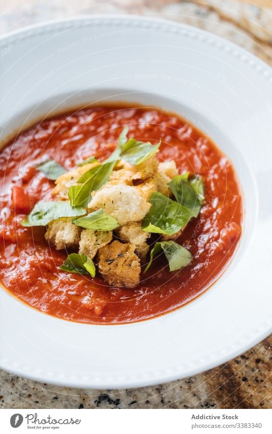 Tomato soup with greens in white plate on table tomato stand dish food delicious lunch cuisine tasty dinner gourmet meal fresh healthy portion vegetable