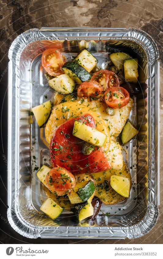 Colorful vegetables with herbs in shiny baking form tomatoes zucchini delicious meal sauce food healthy nutrition fresh tasty lunch dinner cuisine dish gourmet