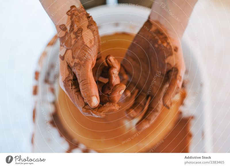 Dirty artisan hands after crafting handmade earthenware in contemporary studio clay pottery workshop dirty crockery master handwork circle person workplace wet