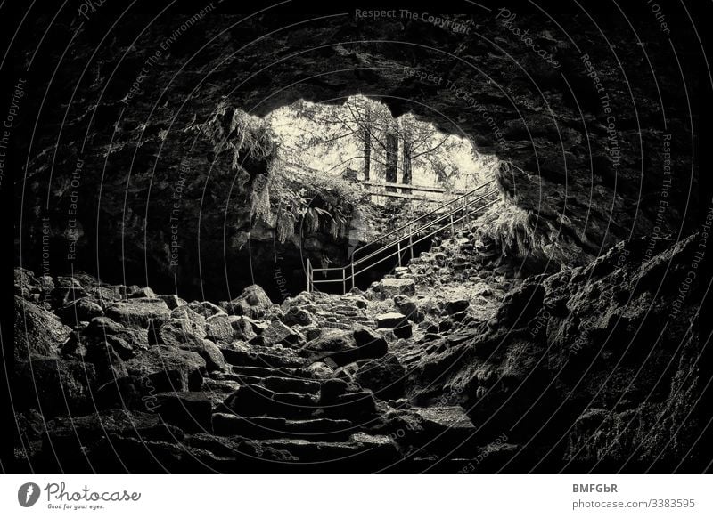 A black and white shot from the Ape Cave, a fantastically shaped lava cave, from the inside to the outside. ape cave Mount St. Helens National Volcanic Monument