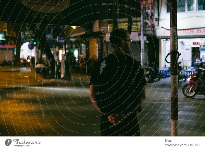 Rear view of a man standing on an empty street in Hanoi and looking to the side Holidaymakers Tourist South East Asia Empty Lonely Doomed Street cross