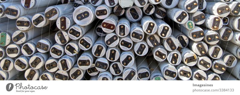 Fluorescent tubes, large amount of used old fluorescent lamps to be recycled. Waste disposal concept for old fluorescent lamp tubes. Ecological background or texture concept. Junkyard Texture Background